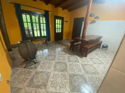 a living room with a bench and a tv at Cabaña Emilia in San Javier