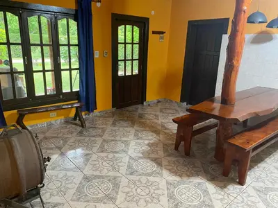 a room with a bench and a table and windows at Cabaña Emilia in San Javier
