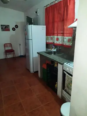 a kitchen with a white refrigerator and a sink at HARD ROCK SERRANO in Santa María