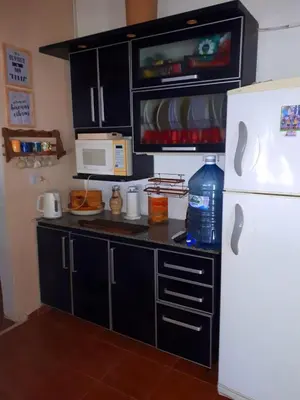a kitchen with a white refrigerator and a microwave at HARD ROCK SERRANO in Santa María