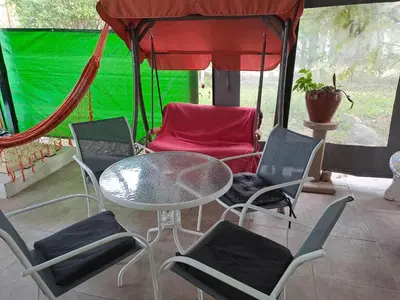 a patio with a table and chairs and a tent at HARD ROCK SERRANO in Santa María