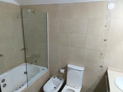 a bathroom with a toilet and a tub and a sink at Aire Serrano in Alta Gracia