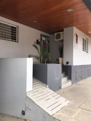 a house with a porch with stairs and a wooden ceiling at Departamento céntrico Villa Carlos Paz in Villa Carlos Paz