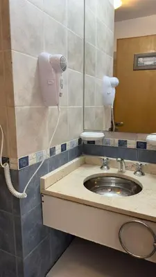a bathroom with a sink and a mirror at Departamento céntrico Villa Carlos Paz in Villa Carlos Paz
