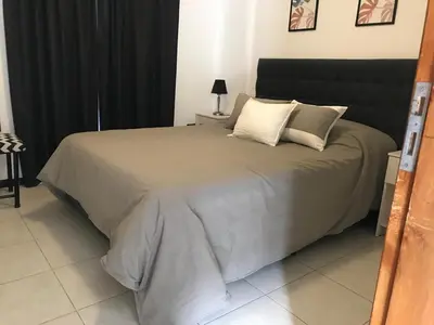 a bedroom with a large bed with two pillows at Departamento céntrico Villa Carlos Paz in Villa Carlos Paz