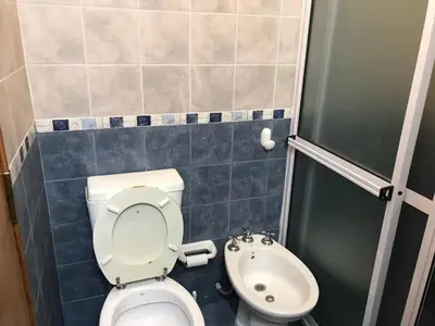 a small bathroom with a toilet and a sink at Departamento céntrico Villa Carlos Paz in Villa Carlos Paz