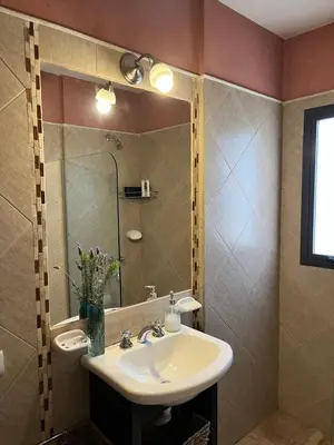 a bathroom with a sink and a mirror at MiraSierras -casas vacacionales- in Villa General Belgrano