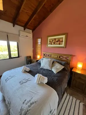 a bedroom with a large bed in a room at MiraSierras -casas vacacionales- in Villa General Belgrano