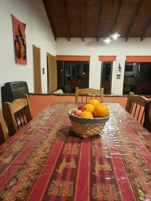 a bowl of fruit on a table with a table cloth at MiraSierras -casas vacacionales- in Villa General Belgrano