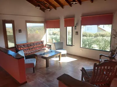 a living room with a couch and a table at MiraSierras -casas vacacionales- in Villa General Belgrano