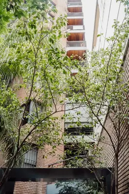 a brick building with trees in front of it at Departamento en calle Paraná by Lofty in Cordoba