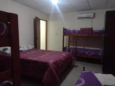 a bedroom with two bunk beds and a window at Complejo de Departamentos DON QUIJOTE in Almafuerte