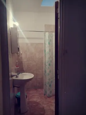 a bathroom with a sink and a shower at Complejo de Departamentos DON QUIJOTE in Almafuerte