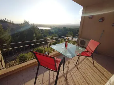 a balcony with a glass table and two chairs at Condominio Monte Molinos - Departamento en Náutico frente al Lago in Villa Ciudad de America