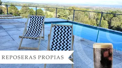 a pair of chairs sitting next to a swimming pool at Condominio Monte Molinos - Departamento en Náutico frente al Lago in Villa Ciudad de America