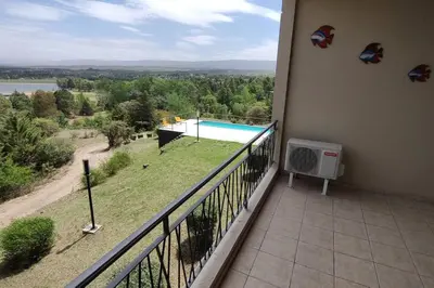 a balcony with a view of a swimming pool at Condominio Monte Molinos - Departamento en Náutico frente al Lago in Villa Ciudad de America