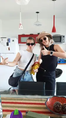 two women standing next to each other in a kitchen at Condominio Monte Molinos - Departamento en Náutico frente al Lago in Villa Ciudad de America