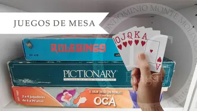 a person holding a stack of books with a hand holding a playing cards at Condominio Monte Molinos - Departamento en Náutico frente al Lago in Villa Ciudad de America