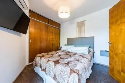 a bedroom with a large bed in a room at Marcelo T de Alvear 628 - B Güemes con Vistas a la Cañada in Cordoba