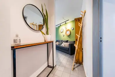a room with a mirror and a table and a couch at Marcelo T de Alvear 628 - B Güemes con Vistas a la Cañada in Cordoba
