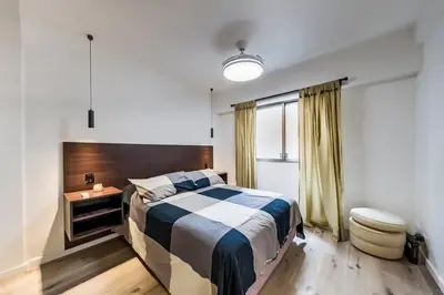 a bedroom with a bed and a toilet in it at San Luis 61 B Nueva Córdoba enfrente al Paseo del Buen Pastor in Cordoba