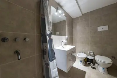 a bathroom with a toilet and a sink and a shower at San Luis 61 B Nueva Córdoba enfrente al Paseo del Buen Pastor in Cordoba
