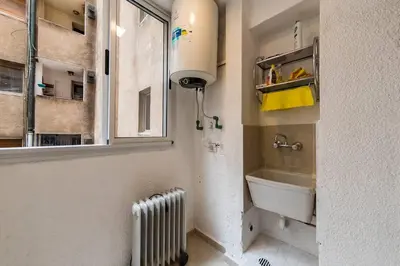 a bathroom with a sink and a window and a radiator at San Luis 61 B Nueva Córdoba enfrente al Paseo del Buen Pastor in Cordoba