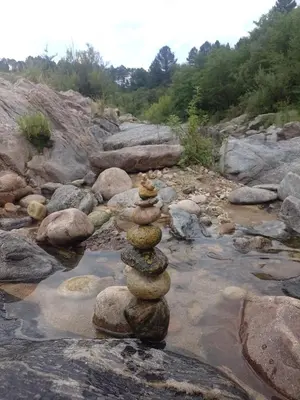 a stack of rocks sitting on top of a river at Casa Desconectar in Villa Berna
