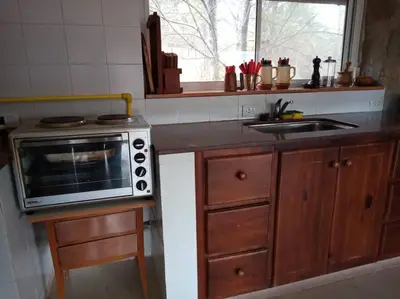 a kitchen with a sink and a microwave at Casa Desconectar in Villa Berna