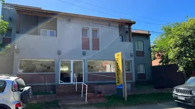 a house with a yellow sign in front of it at Apart Hotel Nonquen in Merlo