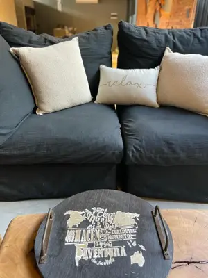 a blue couch with pillows and a table at Loft 1930 in Villa Carlos Paz