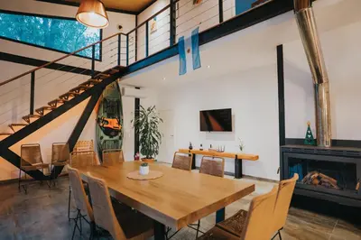 a dining room with a wooden table and chairs at Casa Brunia Lago Los Molinos in Villa General Belgrano