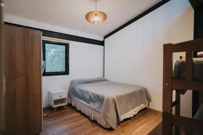 a bedroom with a bed and a window at Casa Brunia Lago Los Molinos in Villa General Belgrano