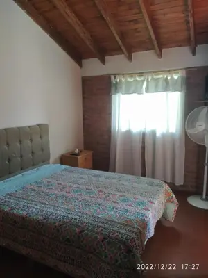 a bedroom with a bed and a window at Departamento CatyDay in Mina Clavero