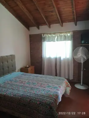 a bedroom with a bed and a window at Departamento CatyDay in Mina Clavero