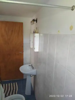 a bathroom with a sink and a toilet at Departamento CatyDay in Mina Clavero