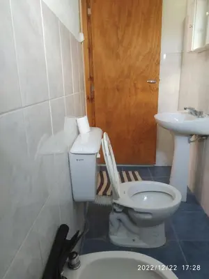 a bathroom with a toilet and a sink at Departamento CatyDay in Mina Clavero