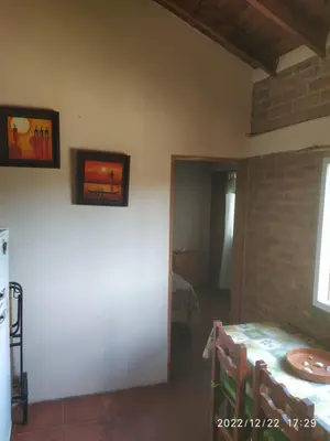 a room with a table and a room with a bed at Departamento CatyDay in Mina Clavero