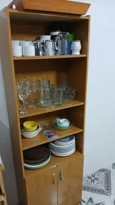 a cabinet filled with dishes and glasses and plates at LOS BULGAROS in Villa Cura Brochero
