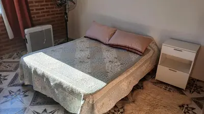 a bedroom with a bed with two night stands at LOS BULGAROS in Villa Cura Brochero