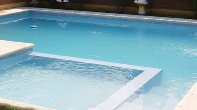 a large swimming pool with blue water in it at LOS BULGAROS in Villa Cura Brochero