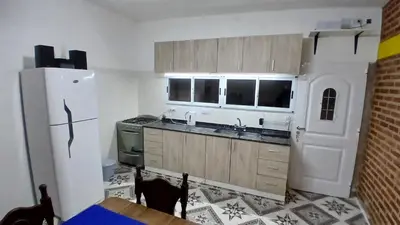 a kitchen with a white refrigerator and a sink at LOS BULGAROS in Villa Cura Brochero