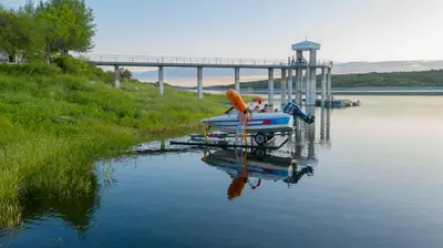 a person is sitting on a boat on the water at Hotel La Huertita in Libertador General San Martín