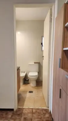 a bathroom with a white toilet and a sink at Centro Av General Paz 418 Estacionamiento economico in Cordoba