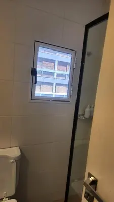 a bathroom with a window and a toilet at Centro Av General Paz 418 Estacionamiento economico in Cordoba