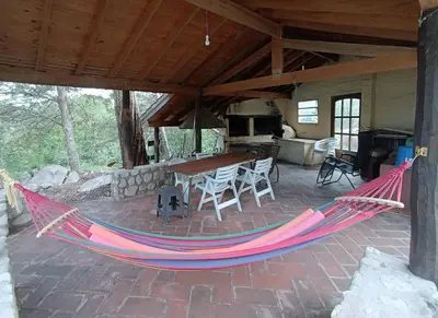 a hammock on the patio of a house at Casa Soleares in Villa de Las Rosas