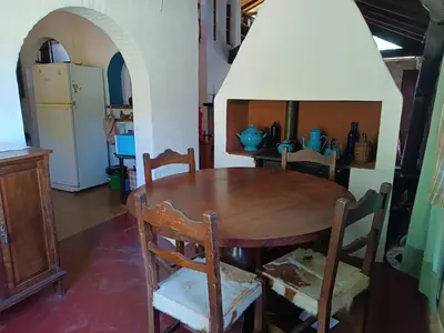 a dining room with a wooden table and chairs at Casa Soleares in Villa de Las Rosas