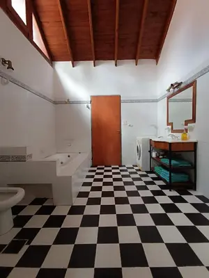 a bathroom with a black and white checkered floor at Casa Soleares in Villa de Las Rosas