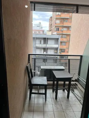 a balcony with a table and chairs and a window at Castel Di Lucio 6 - Pleno centro Cba - in Cordoba