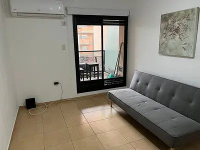 a living room with a couch and a window at Castel Di Lucio 6 - Pleno centro Cba - in Cordoba